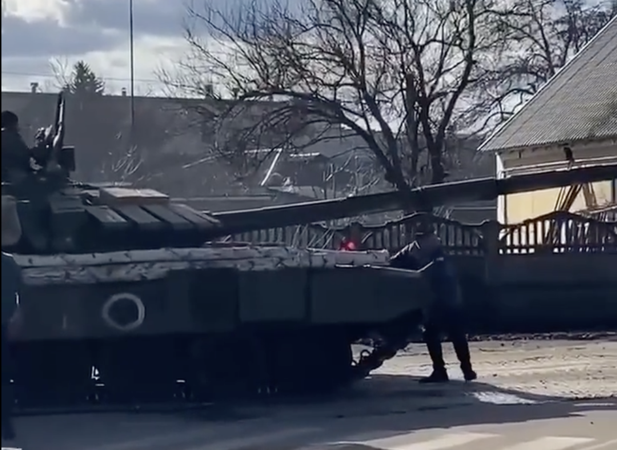 Ukrainian man kneels in front of Russian tank after trying to stop it with his bare hands