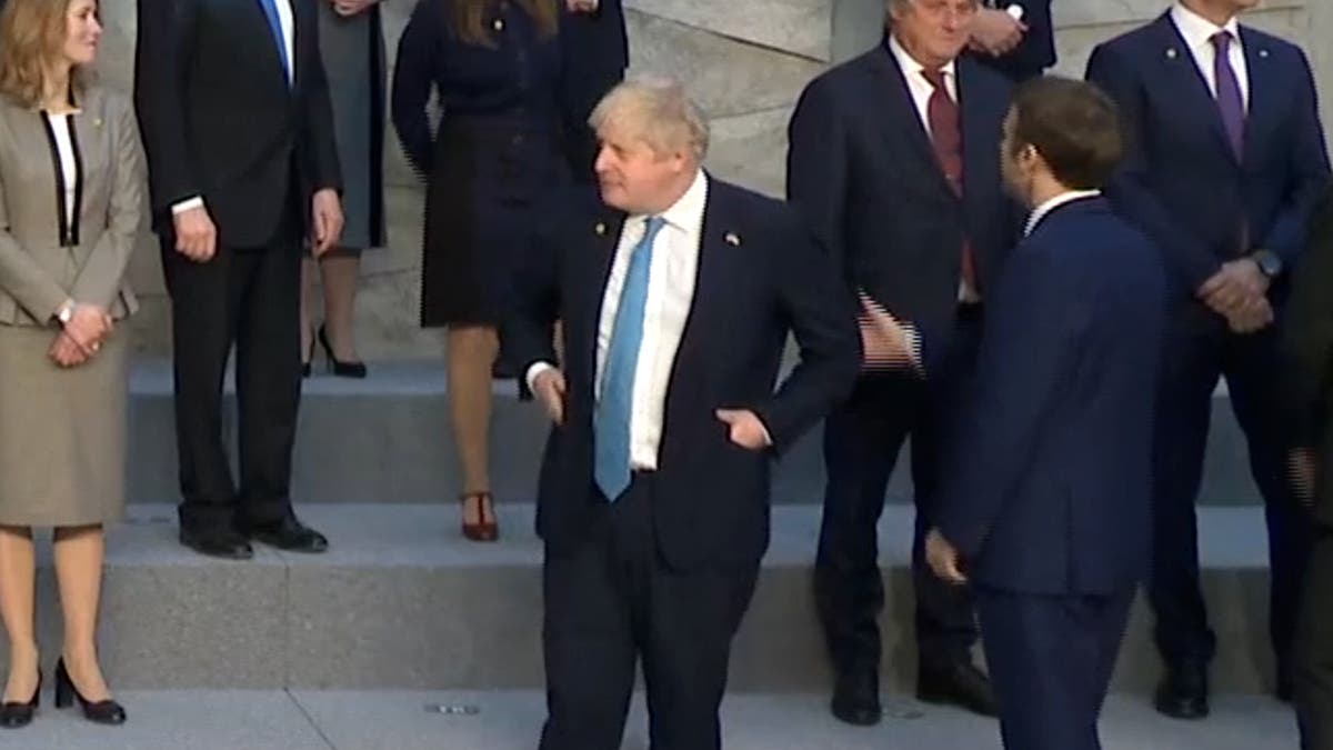 Boris Johnson looks on awkwardly as Macron and other EU leaders greet at Nato meeting
