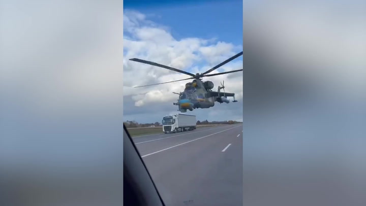 Low-flying attack helicopter narrowly misses vehicles on Ukraine road | News